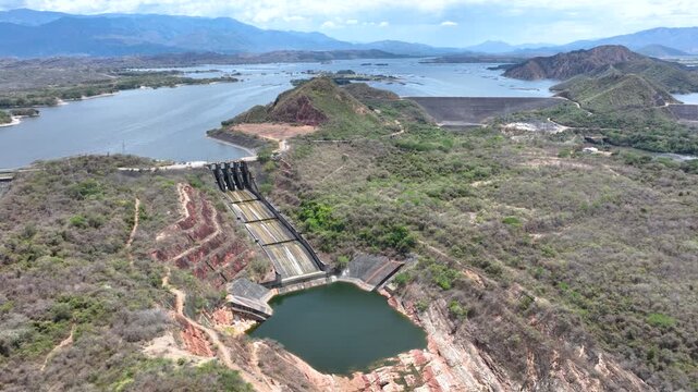 Betania Reservoir and Hydroelectric Dam Surrounded by Mountains in Colombia. Establishing Shot. Aerial View.