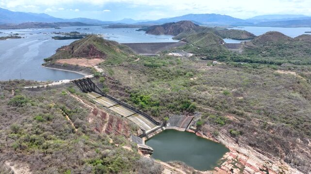 Betania Reservoir and Hydroelectric Dam Surrounded by Mountains in Colombia. Establishing Shot. Aerial View.