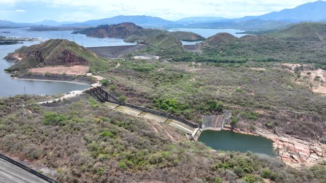 Betania Reservoir and Hydroelectric Dam Surrounded by Mountains in Colombia. Establishing Shot. Aerial View.
