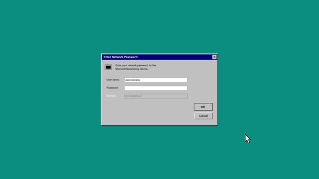 Old computer login screen with username and password fields, featuring a blue dialog box with 'OK' and 'Cancel' buttons on a green background