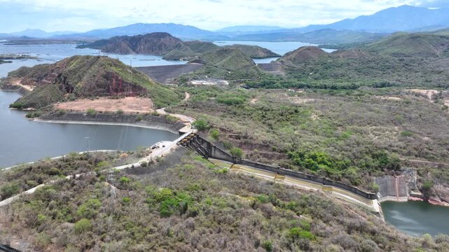 Betania Reservoir and Hydroelectric Dam Surrounded by Mountains in Colombia. Establishing Shot. Aerial View.