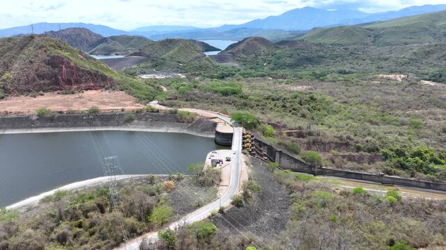 Hydroelectric Dam and Reservoir with Spillway and Energy Infrastructure. Establishing Shot. Aerial View.