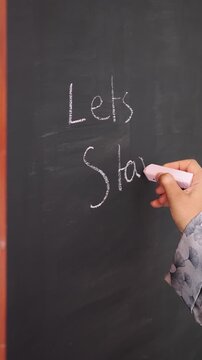 Hand Writing Lets Start on a Blackboard with Chalk