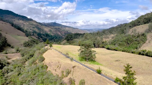 Cocora Valley Iconic Wax Palms and Green Andean Mountains near Salento, Colombia. Establishing Shot. Aerial View.