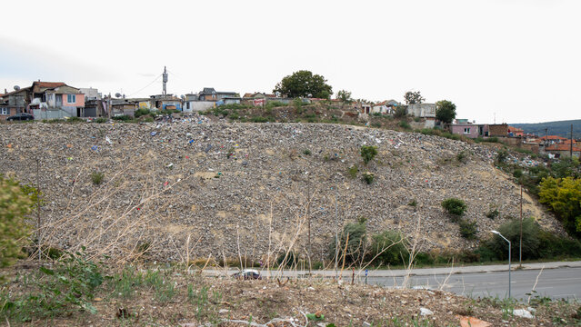 Roma neighborhood on the edge of an urban area with roadside waste