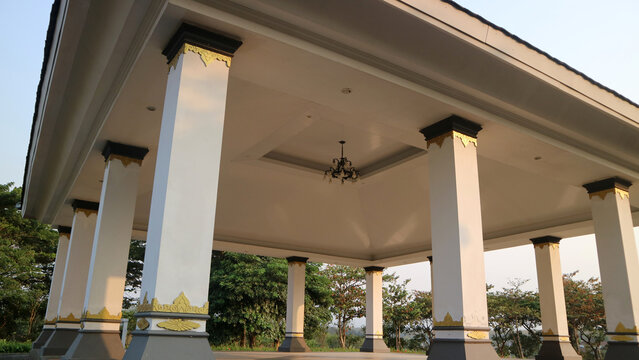 Elegant pavilion building with white pillars and golden decorative ornaments outdoor