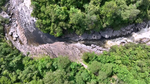 Estrecho del Magdalena River Rapids Surrounded by Rock Formations and Tropical Forest in Colombia. Slow Motion. Establishing Shot. Aerial View.