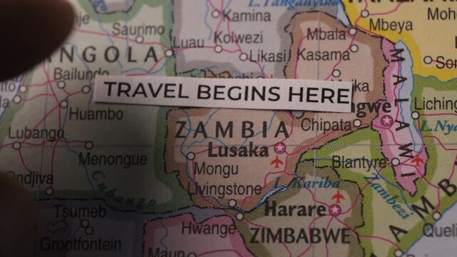 Paper Strip With Text Travel Begins Here Placed on Map of Africa