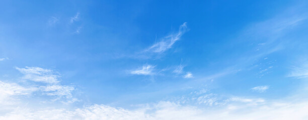 Soft clouds drift across vast, clear blue sky © lovelyday12