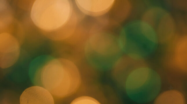 Abstract bokeh background with blurred green and gold light circles