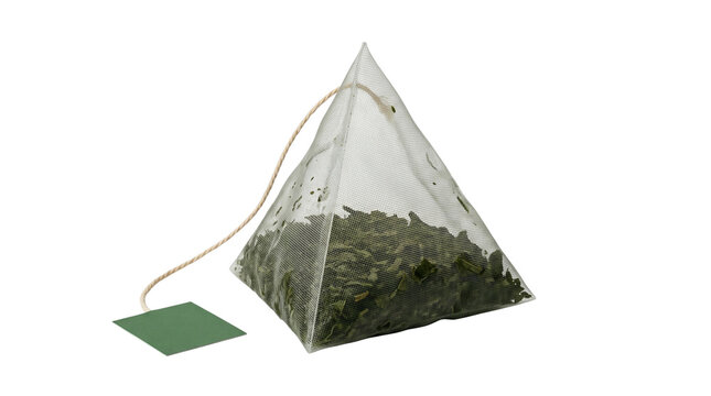 Pyramid tea bag filled with green tea leaves, attached to a string and a green paper tag, isolated on transparent background