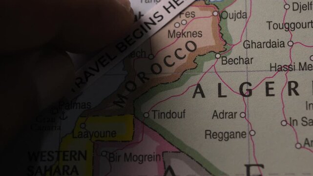 Travel Begins Here Paper Strip Placed on Map of Morocco Tourism Concept
