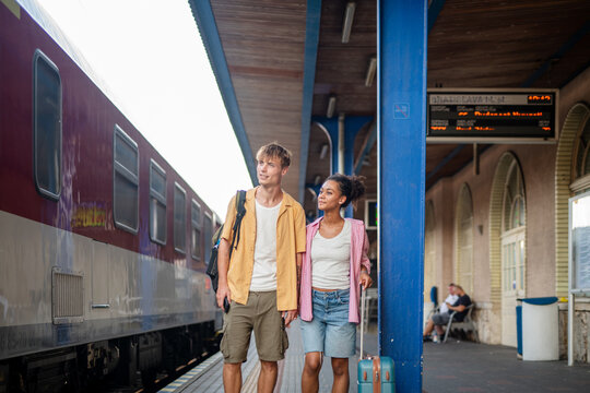 University student couple traveling by train to campus for new semester.