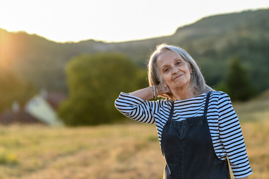 Senior woman enjoying gentle outdoor activity and connection with nature.
