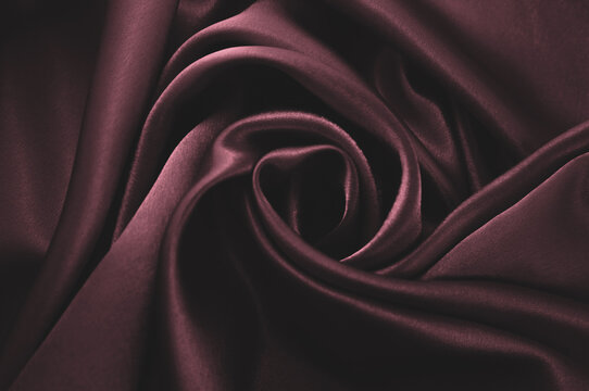 Dark red silk fabric draped background