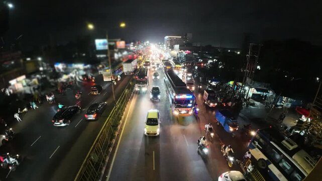 Busy Night Road Traffic and Street Lights in Bhubaneswar, Odisha, India. Indian City Road Traffic at Night with Vehicles, Buses, and Motorcycles Under Streetlights. 