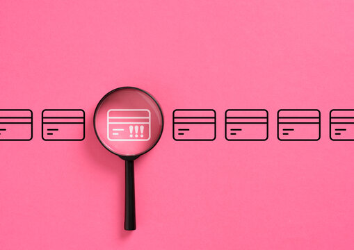 Magnifying glass identifying fraud on credit card icon