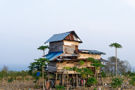 Dilapidated wooden stilt house reflecting poverty and housing inequality