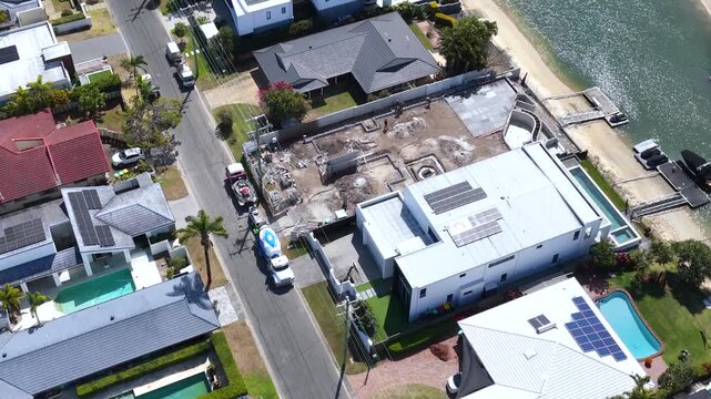 Aerial View of Waterfront Real Estate Construction Site and Luxury Homes
