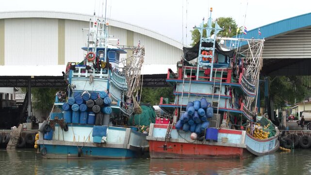Moored Wooden Fishing Trawlers Docked at Industrial Harbor Port