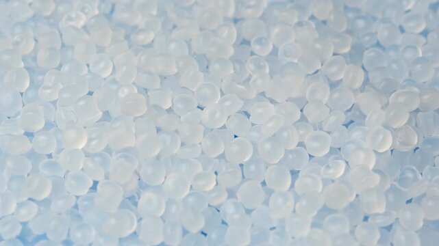 Polyethylene pellets fall onto rotating layer as feedstock for medical and plastic manufacturing.