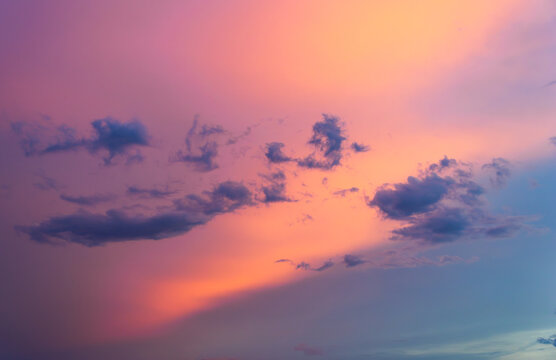 Vibrant pink and purple sunset clouds fill the evening sky, symbolizing climate change and atmospheric shifts during twilight.