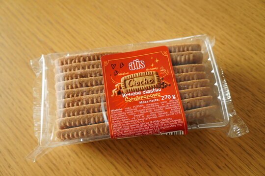 A package of Atis Ciocho cinnamon shortbread cookies resting on a light wooden table surface