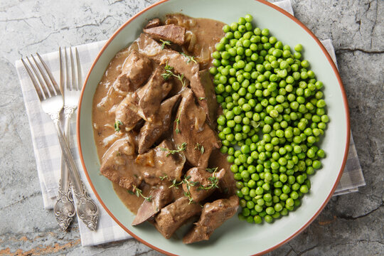 liver in wine sauce is a specialty from the Baden region or Southern Germany closeup on the plate on the table. Horizontal top view from above