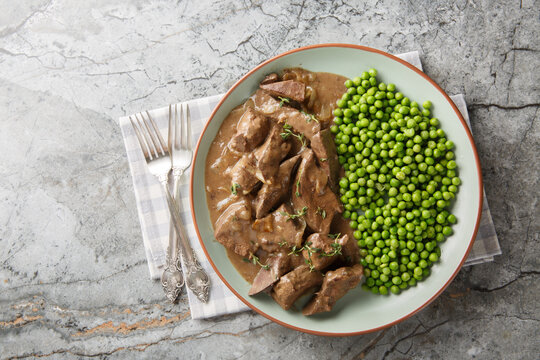 Liver Baden Style or Badisches Saures Leberle, is a traditional Southern German dish featuring tender strips of liver cooked in a white wine sauce. Horizontal top view from above