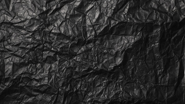 しわくちゃの黒い紙の背景テクスチャー