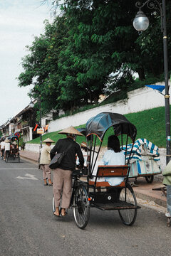 Luang Prabang, May 2026 

Groups of people ride through the old streets on cyclo, passing rows of weathered colonial buildings, quiet caf&eacute;s, and travelers wandering by with their cameras. 