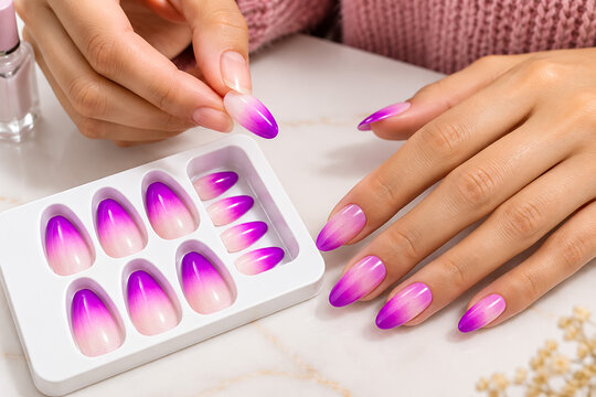 Person applying gradient purple nail polish from tray for nail art
