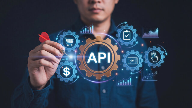 Professional businessman holding red dart while interacting with futuristic API interface and glowing icons