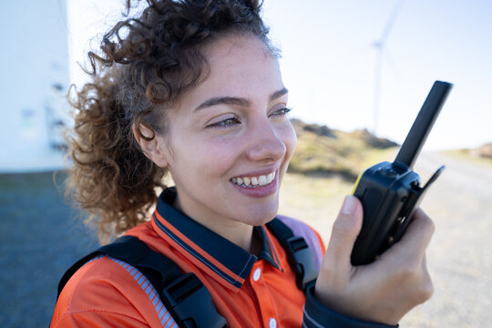 White woman communicates with walkie talkie