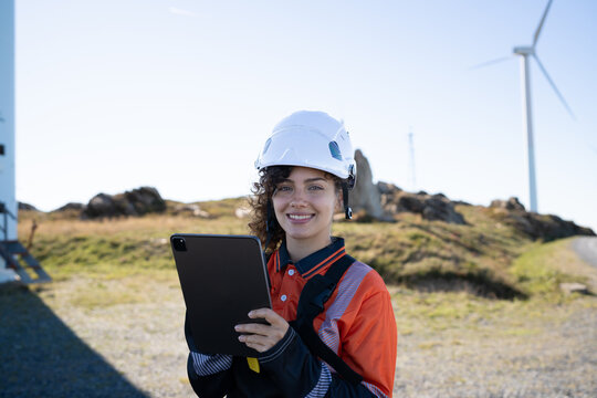 Female engineer holding tablet at wind farm in Galicia Spain