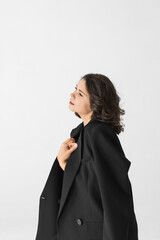 Inspiring profile portrait of forty year old woman looking up with jacket draped on shoulder. © Olga