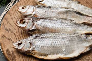 Fresh dried fish arranged on wooden board © Vitaliy
