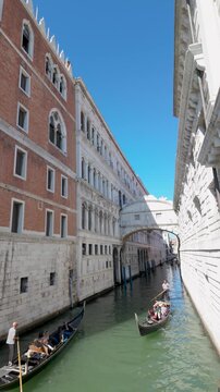 Venice canal with gondolas passing beneath the historic Bridge