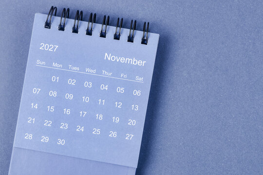November 2027 Monthly desk calendar for 2026 year on blue background.