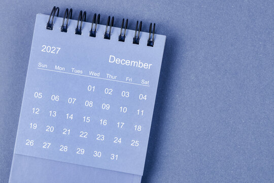 December 2027 Monthly desk calendar for 2026 year on blue background.
