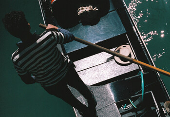 analog film photo of traditional gondola boat in a channel in Venice in Italy, tourist landmark © davide bonaldo