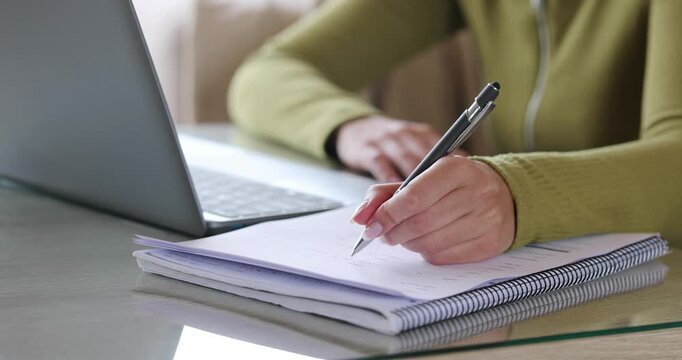 Student hand filling out form at home