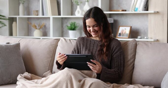 Happy young woman laughing checking tablet