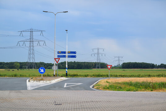 Empty country road and power line in the Netherlands