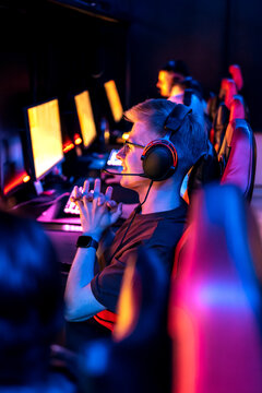 Young man wearing headset competes in esports game