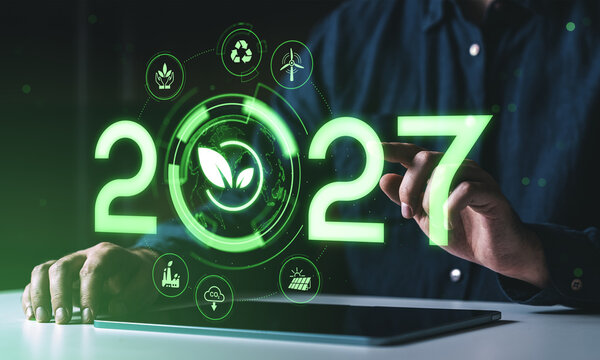 2027 sustainability forecast concept with glowing green environmental icons, renewable energy, recycling and climate technology interface on laptop screen.