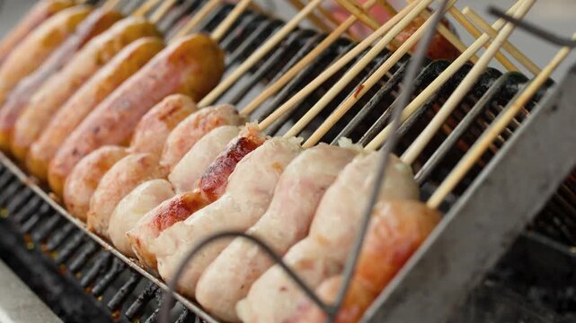 Thai Pork Sausages Grilling on Charcoal Barbecue Skewers