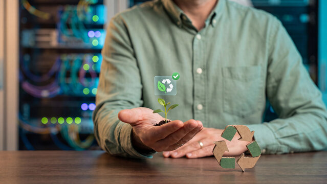 Green technology and recycling sustainability concept, hand holding seedling plant with recycle symbol and server for eco friendly business, carbon reduction and renewable energy future
