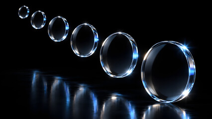 Fototapeta premium Row of glowing glass rings with blue light reflections on glossy black background in diminishing perspective