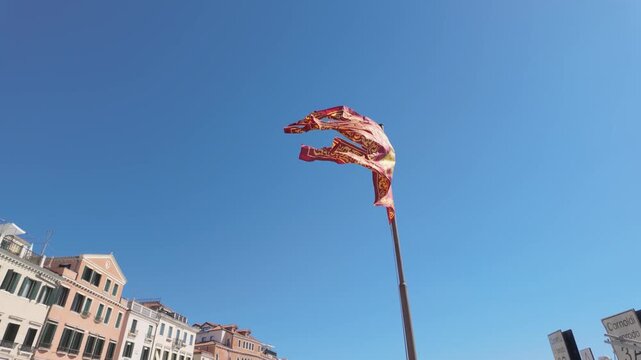 Venetian flag waving on a tall pole